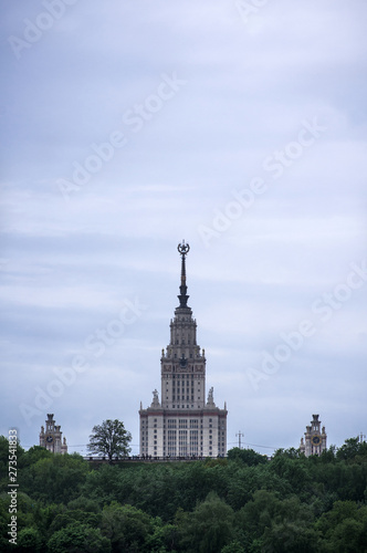 The main building of the Moscow state University rises above the trees. Russia, Moscow. The building of Stalin's times