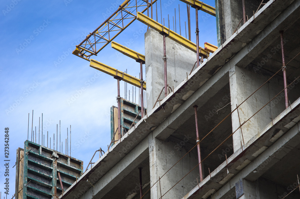 Building under construction on blue sky background. Concreting