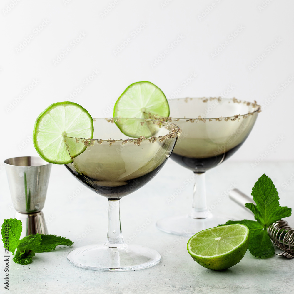 empty margarita cocktail glasses on a table with bar accessories empty margarita cocktail glasses on a table with bar accessories