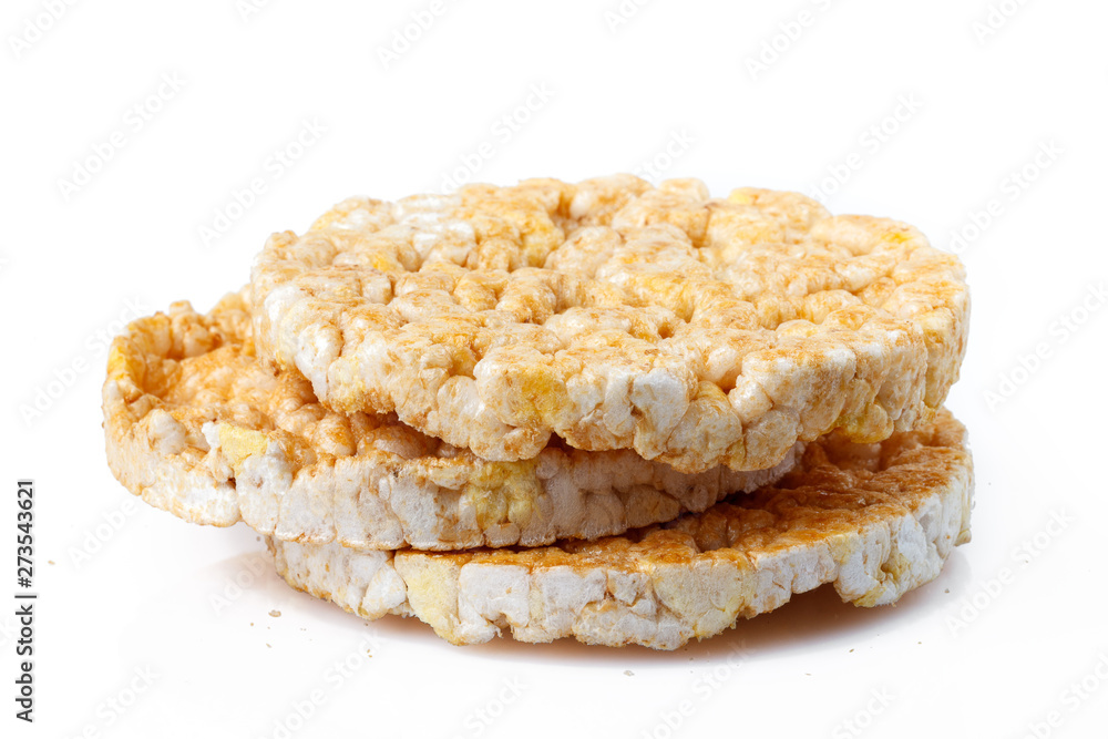 Caramelized corn cakes. Puffed whole grain crispbread isolated on white background. Close-up. Caramelized corn cakes. Puffed whole grain crispbread isolated on white background. Close-up.