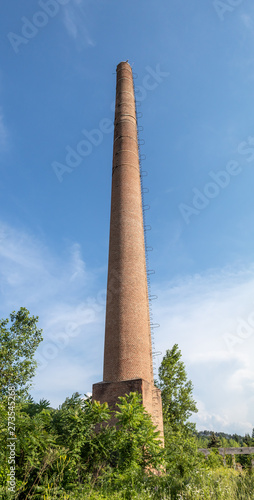 Very Tall Red Brick Industrial Chimney With Metal Lightning Rod