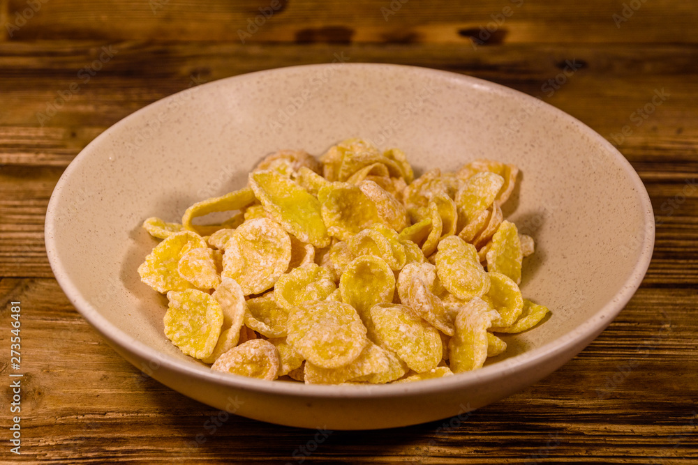 Ceramic plate with cornflakes on a wooden table. Healthy eating Ceramic plate with cornflakes on a wooden table. Healthy eating