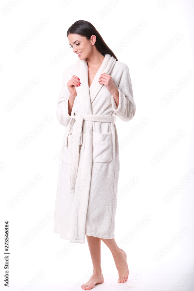 Studio shoot of model in white bathrobe looking down. Studio shoot of model in white bathrobe looking down.