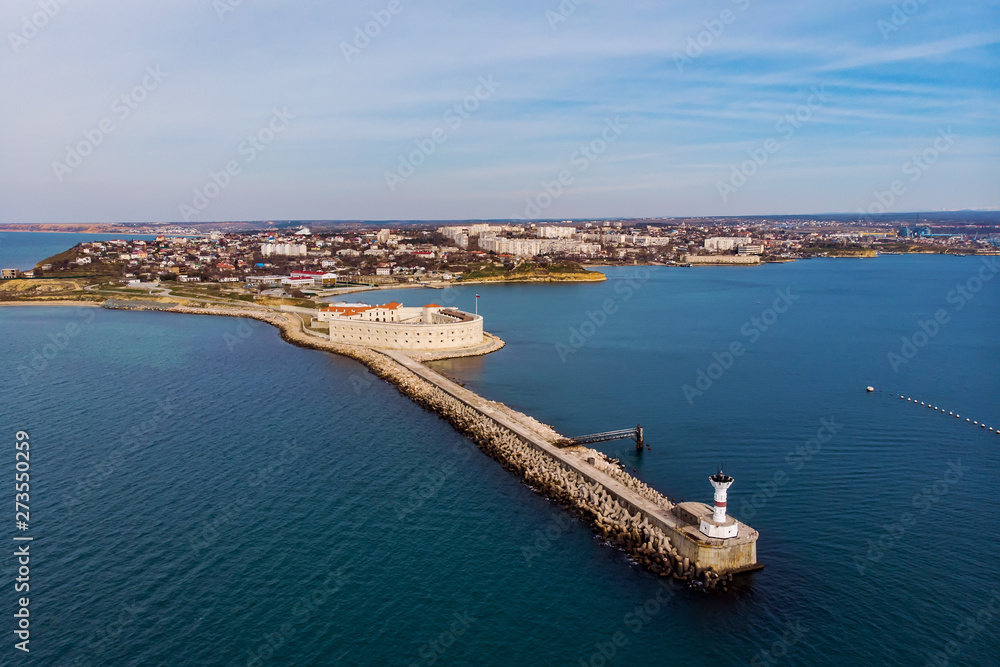 Aerial view of Konstantinovskaya battery in Sevastopol Bay in Crimea. Sea landscape with coastline and cityscape on background