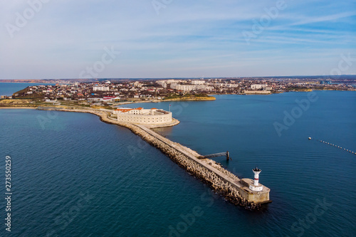 Aerial view of Konstantinovskaya battery in Sevastopol Bay in Crimea. Sea landscape with coastline and cityscape on background © DedMityay