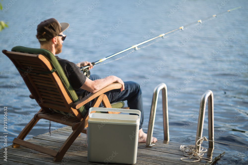 Mature man fishing from gangway Mature man fishing from gangway