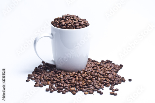 White cup with coffee beans on white background