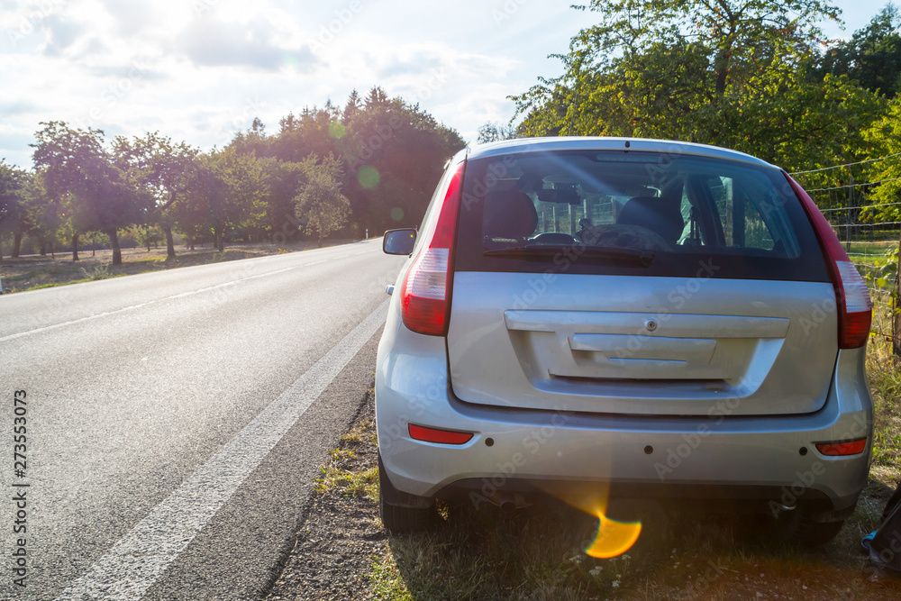 Car on the road and landscape with field and sky Car on the road and landscape with field and sky