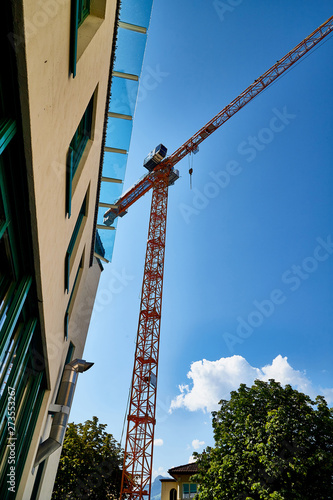 Tower crane and building against mountain and sky