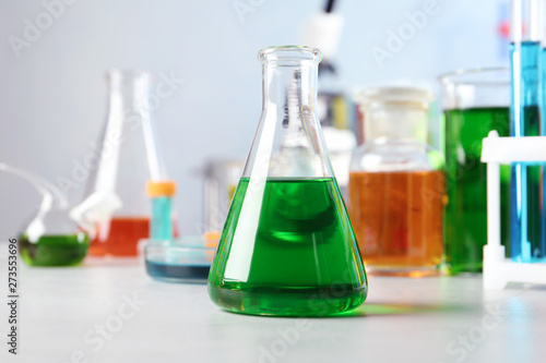 Conical flask and other glassware on table in chemistry laboratory