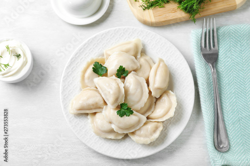 Flat lay composition with tasty dumplings served on white table photo