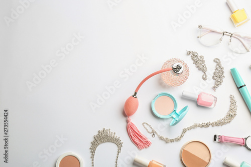 Composition with perfume bottle, cosmetics and accessories on white background, top view