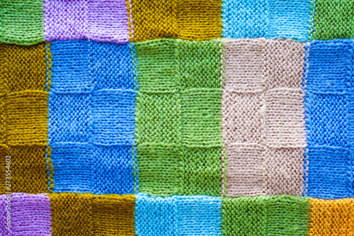 texture of multicolored fragments of knitted cover,background of colorful threads 