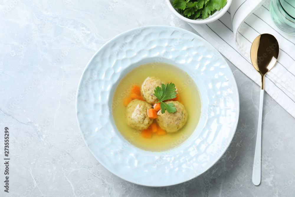 Flat lay composition with Jewish matzoh balls soup on light table Flat lay composition with Jewish matzoh balls soup on light table