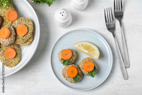 Flat lay composition with traditional Passover (Pesach) gefilte fish on wooden background