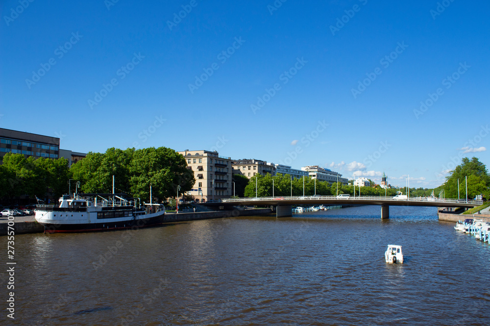 Bridge over the river Auraioki and old vintage ship in Turku city in Finland on a summer day.