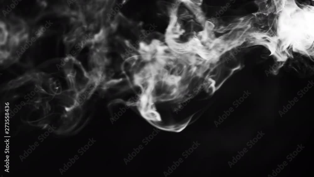 White clouds of vapor smoke are isolated on a black background. Gas explodes, swirl and dances in space. A magic fog dust texture effect that can be used by overlay and changing their transparency. White clouds of vapor smoke are isolated on a black background. Gas explodes, swirl and dances in space. A magic fog dust texture effect that can be used by overlay and changing their transparency.