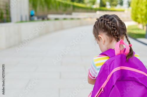 First day of school. Happy child girl elementary school student runs to class. concept back to school.