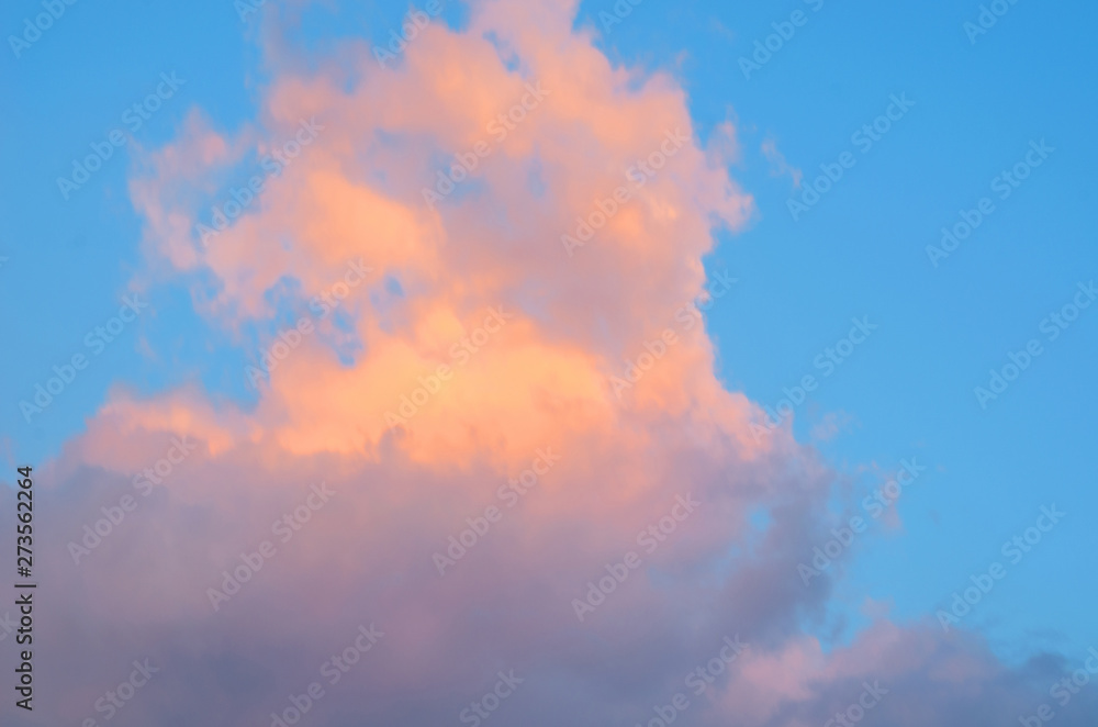 Clouds with orange in the sky that are blue from the sun. It is a good background image.