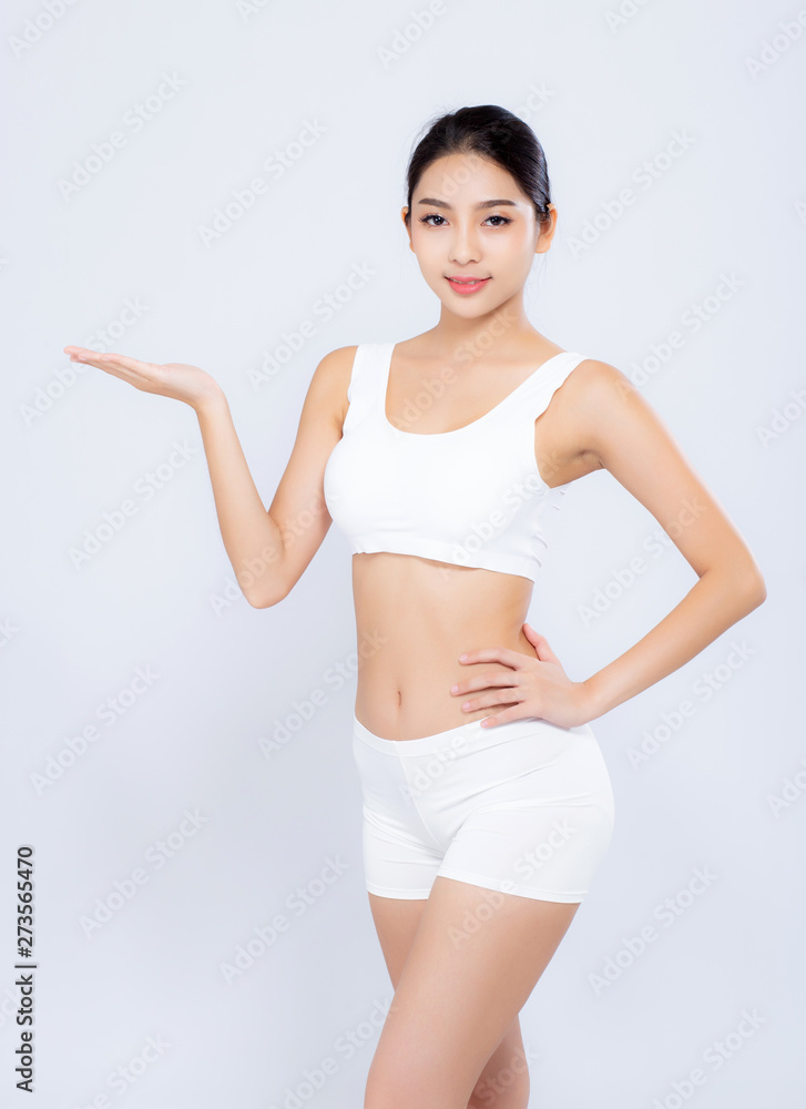 Portrait young asian woman smiling beautiful body diet with fit presenting something empty copy space on the hand isolated on white background, model girl weight slim, health and wellness concept. Portrait young asian woman smiling beautiful body diet with fit presenting something empty copy space on the hand isolated on white background, model girl weight slim, health and wellness concept.