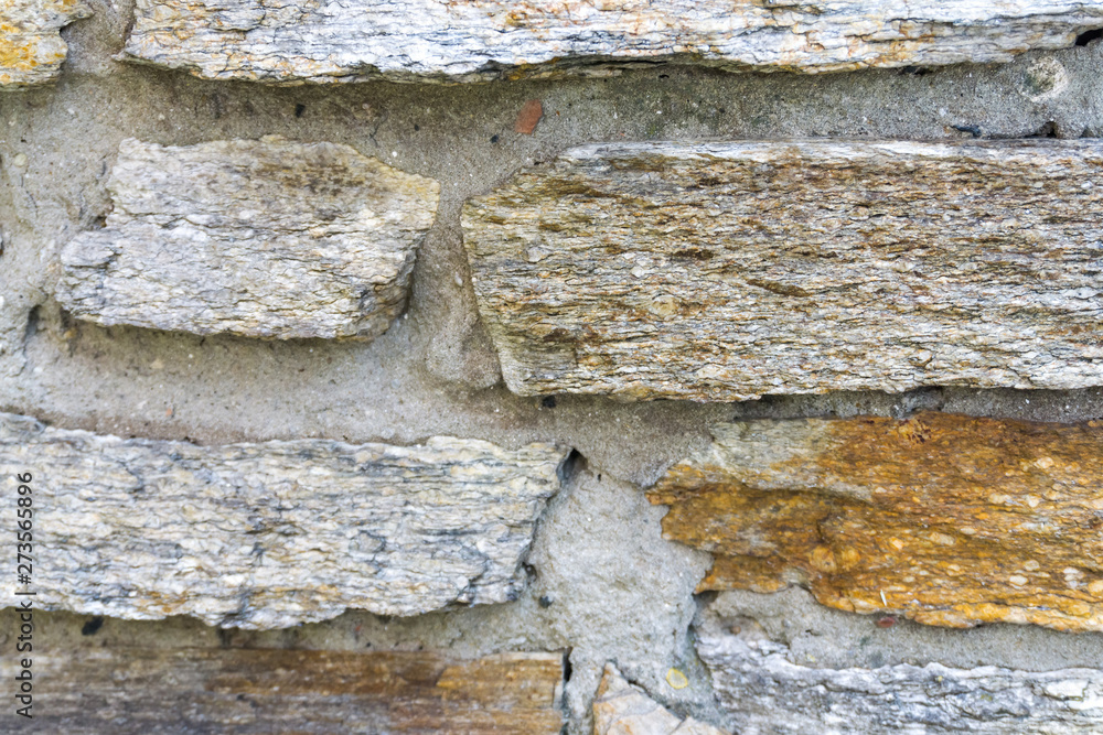 Fototapeta premium Full frame of Old beige stone wall background texture