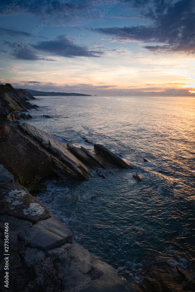 scenic view with sunset on atlantic ocean with rocks in socoa, basque country, france