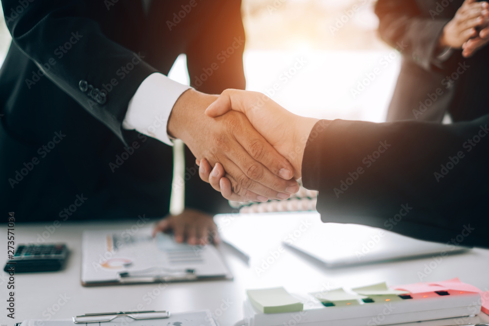 Business people partners shaking hands after complete agreement plan in meeting room, investment concept, success concept