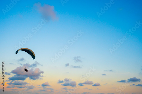 paraglider flying on sky at sunset