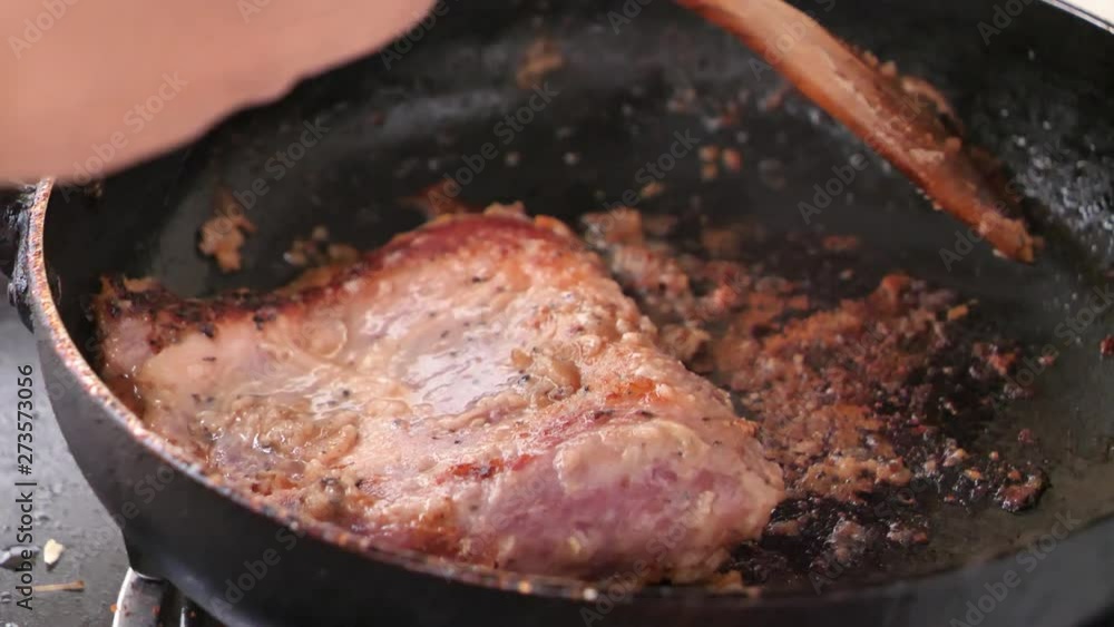 Close-up shot cooking and grill pork steak in the hot pan Close-up shot cooking and grill pork steak in the hot pan