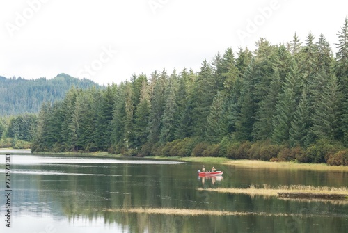 Fishing in a boat inside a lake in nature nice landscape Alaska