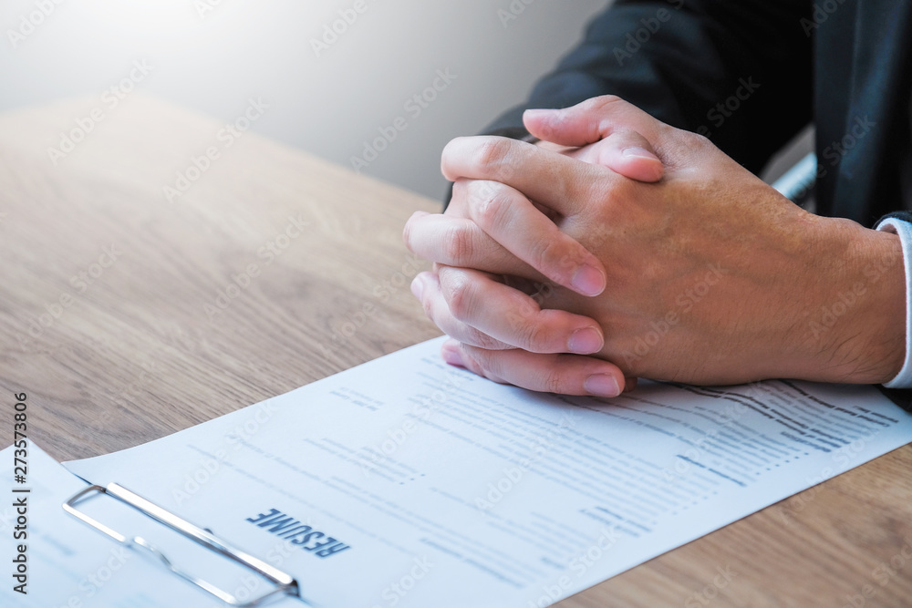 Senior manager reading a resume during a job interview employee young man meeting Applicant and recruitment