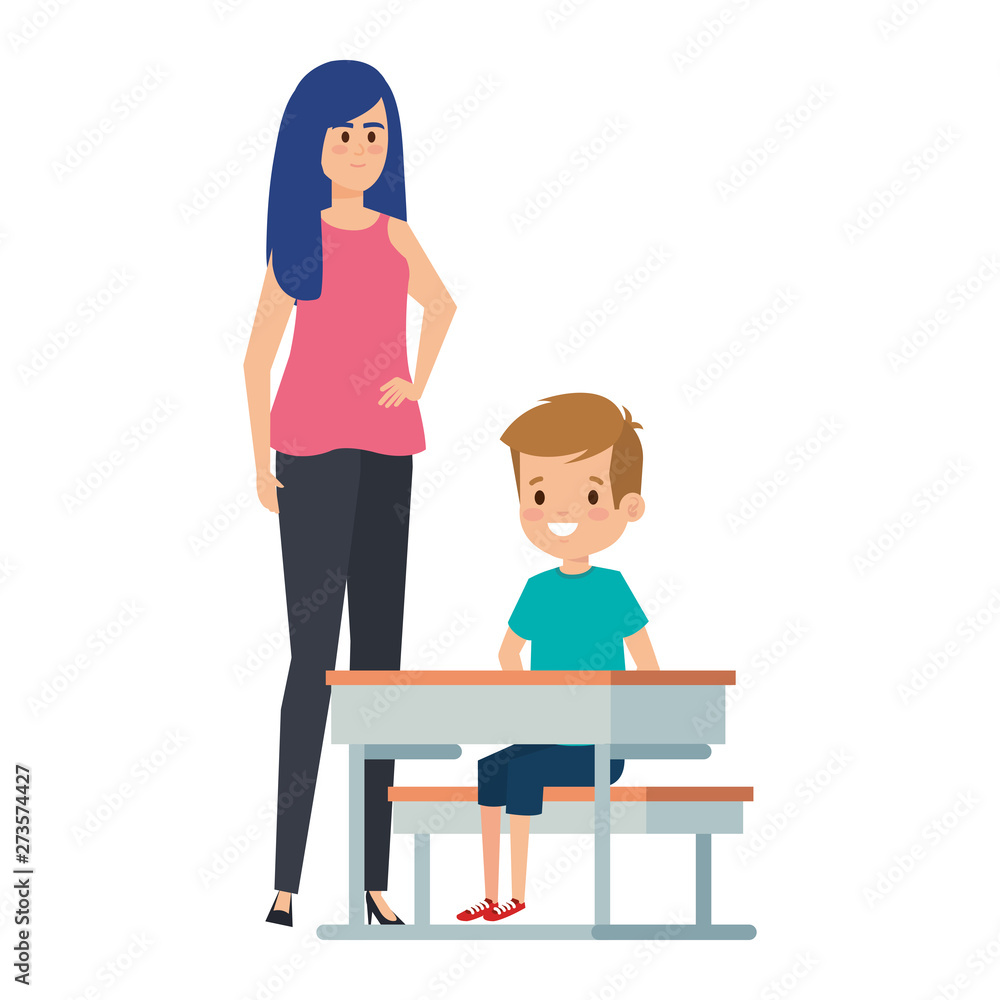 student boy seated in school desk with female teacher student boy seated in school desk with female teacher