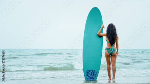 female in bikini happy playing wave board