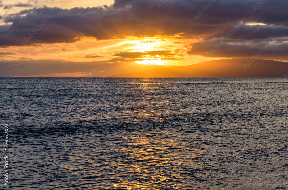 Ocean Sunset - Colorful sunset at north-west coast of Maui, with Lanai island at horizon. Hawaii, USA.