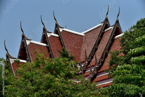 Luscious red Buddhist temple roof with clear blue sky