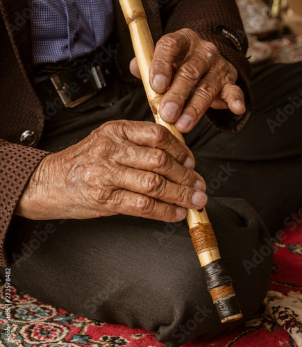 Iranian Hill Tribe Man Plays His Flute. © mindstorm