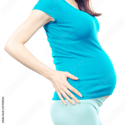Pregnant woman with hands on her back, pregnancy health care and back aches
