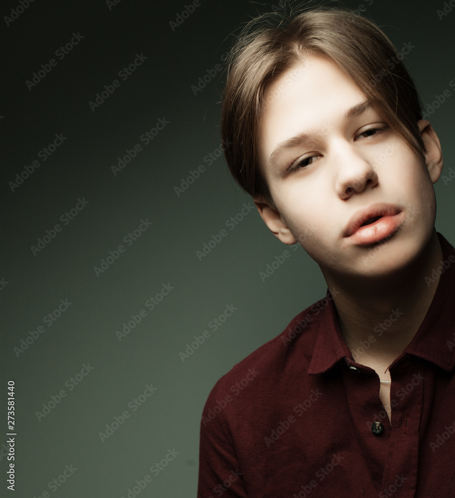 Fashion and people concept: stylish trendy young man dressed in casual clothes posing in over gray background Fashion and people concept: stylish trendy young man dressed in casual clothes posing in over gray background