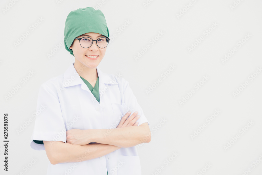 Portrait of young Asian doctor in surgery uniform with white coat isolated on white wall background. Portrait of young Asian doctor in surgery uniform with white coat isolated on white wall background.
