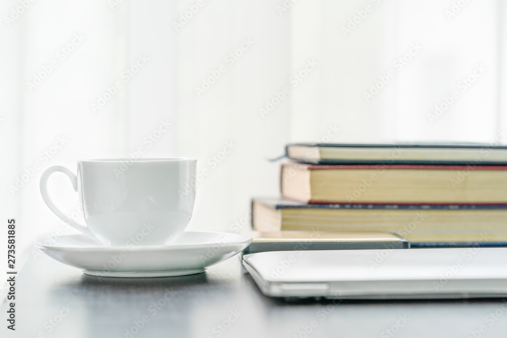 Coffee cup and book on table Coffee cup and book on table