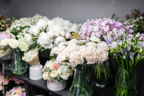 Vases with different colored flowers  showcase flower shop. Beautiful spring bouquets. . Small family business. Work florist. copy space