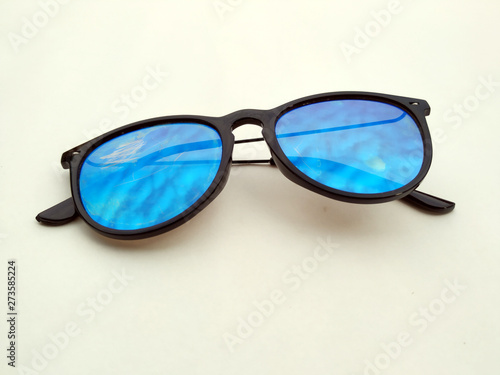 Children sunglasses, sun shades or spectacles isolated on yellow background. Color child glasses protection from sun and UV rays. Concept of sun protection and vacation.