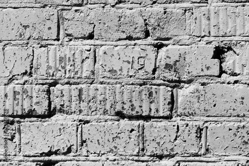 Old painted brick wall close up. Monochrome abstract background