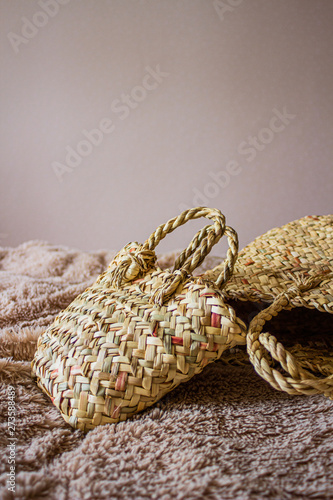 Beautiful female straw hand bag on natural background.