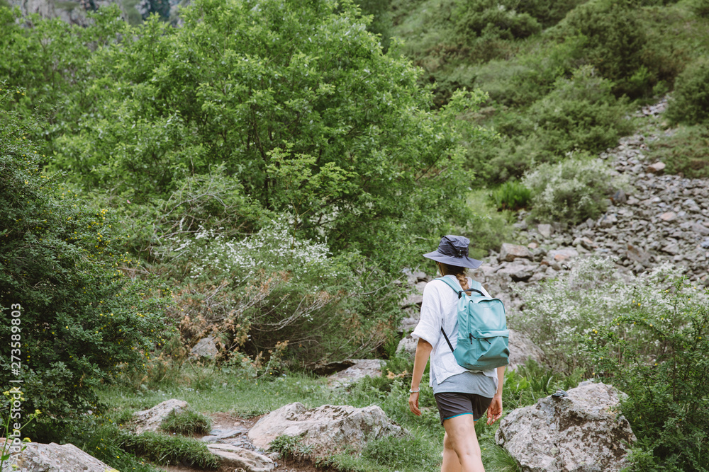 Young lady tourist hiking in the mountains of Georgia Young lady tourist hiking in the mountains of Georgia