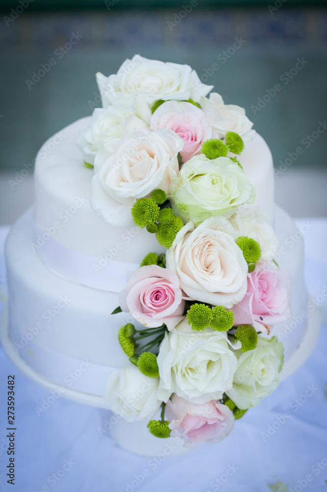 White wedding cake with real roses White wedding cake with real roses