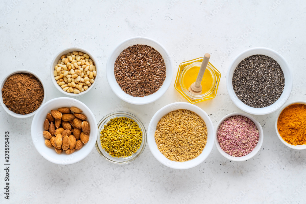 Healthy super food clean eating selection (seeds, powder turmeric, carob, nuts, honey, bee pollen, dried beet) Healthy super food clean eating selection (seeds, powder turmeric, carob, nuts, honey, bee pollen, dried beet)