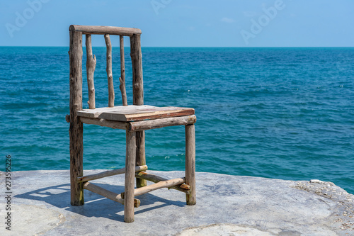 Wooden chair in empty cafe next to sea water in tropical beach . Island Koh Phangan  Thailand