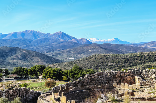 Mighty ruins of ancient and well-built Mycenae rich in gold - home of the mythical Agamemnon synonymous with the names Homer and Schliemann with mountains of the Peloponnese covered with olives photo