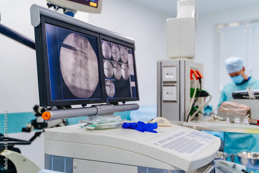 Modern equipment in operating room. Spine Surgery. Group of surgeons in operating room. Modern equipment in operating room. Spine Surgery. Group of surgeons in operating room.